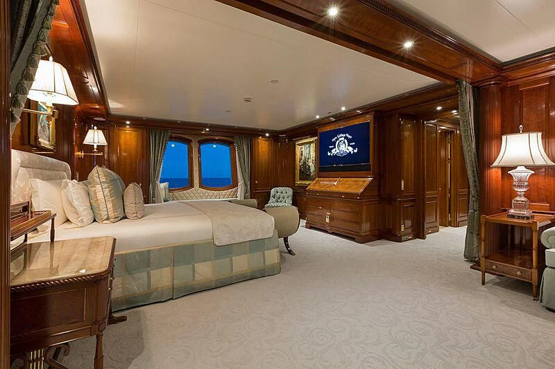 a bedroom with a bed and a tv aboard KATHARINE Yacht for Sale