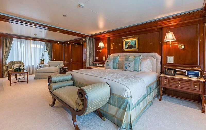 a bedroom with a bed and a couch aboard KATHARINE Yacht for Sale