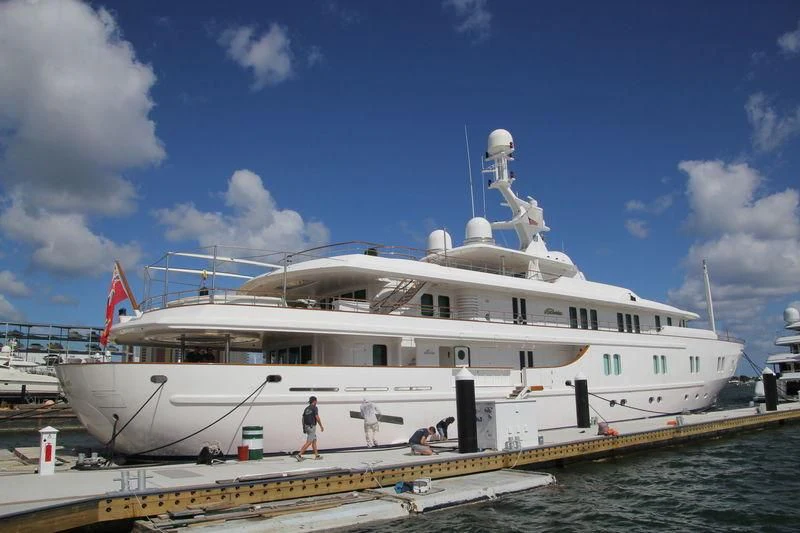 a large white boat with a flag on the front aboard KATHARINE Yacht for Sale