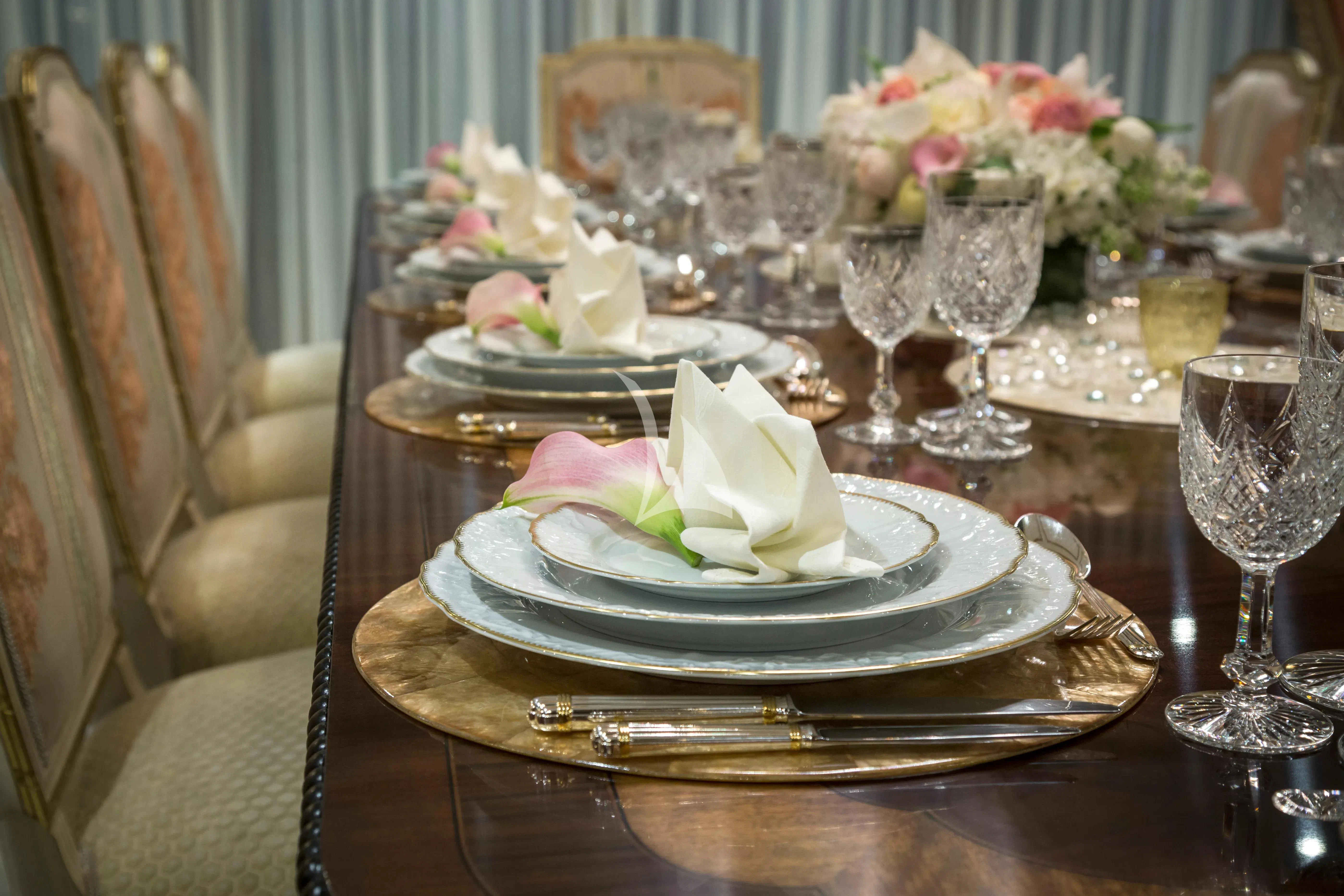 a table with a plate of food and glasses on it aboard KATHARINE Yacht for Sale