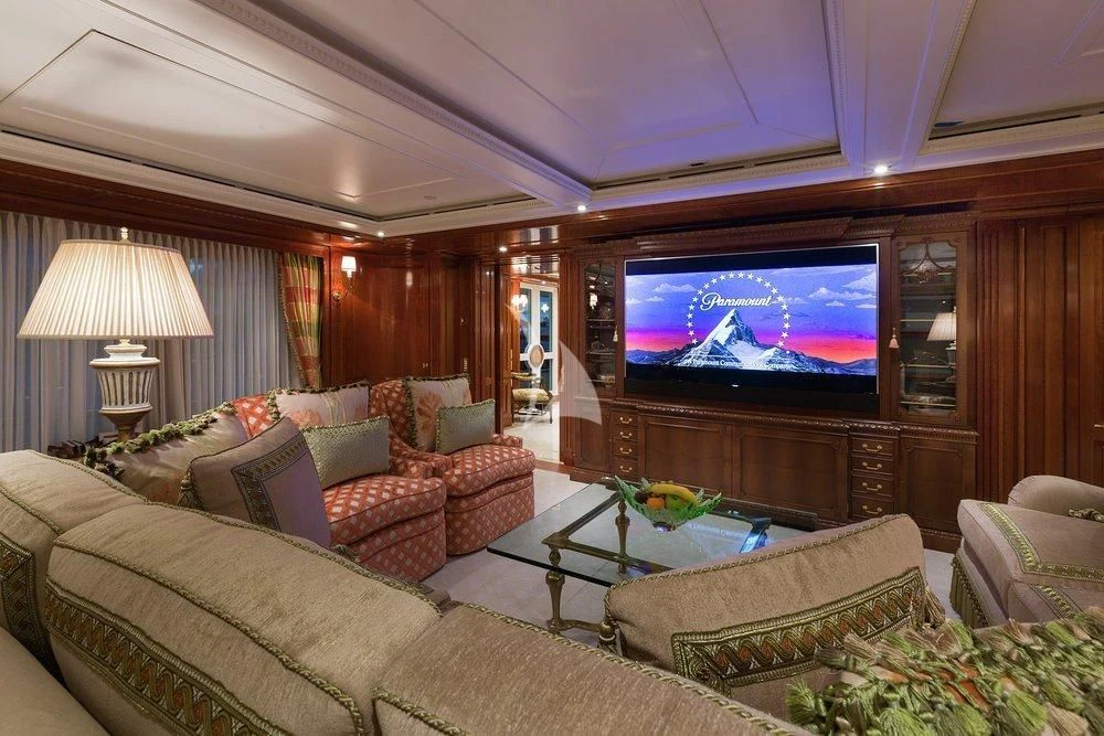 a living room with a tv and couches aboard KATHARINE Yacht for Sale