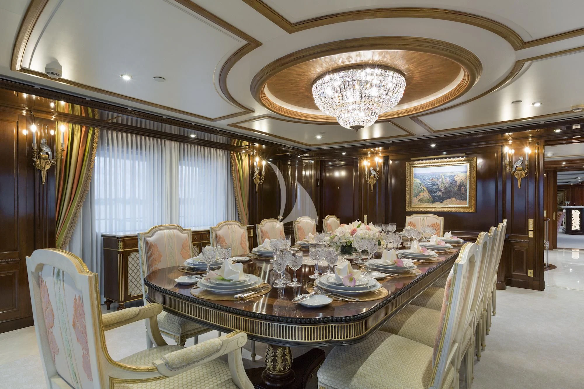 a large dining room with a chandelier aboard KATHARINE Yacht for Sale
