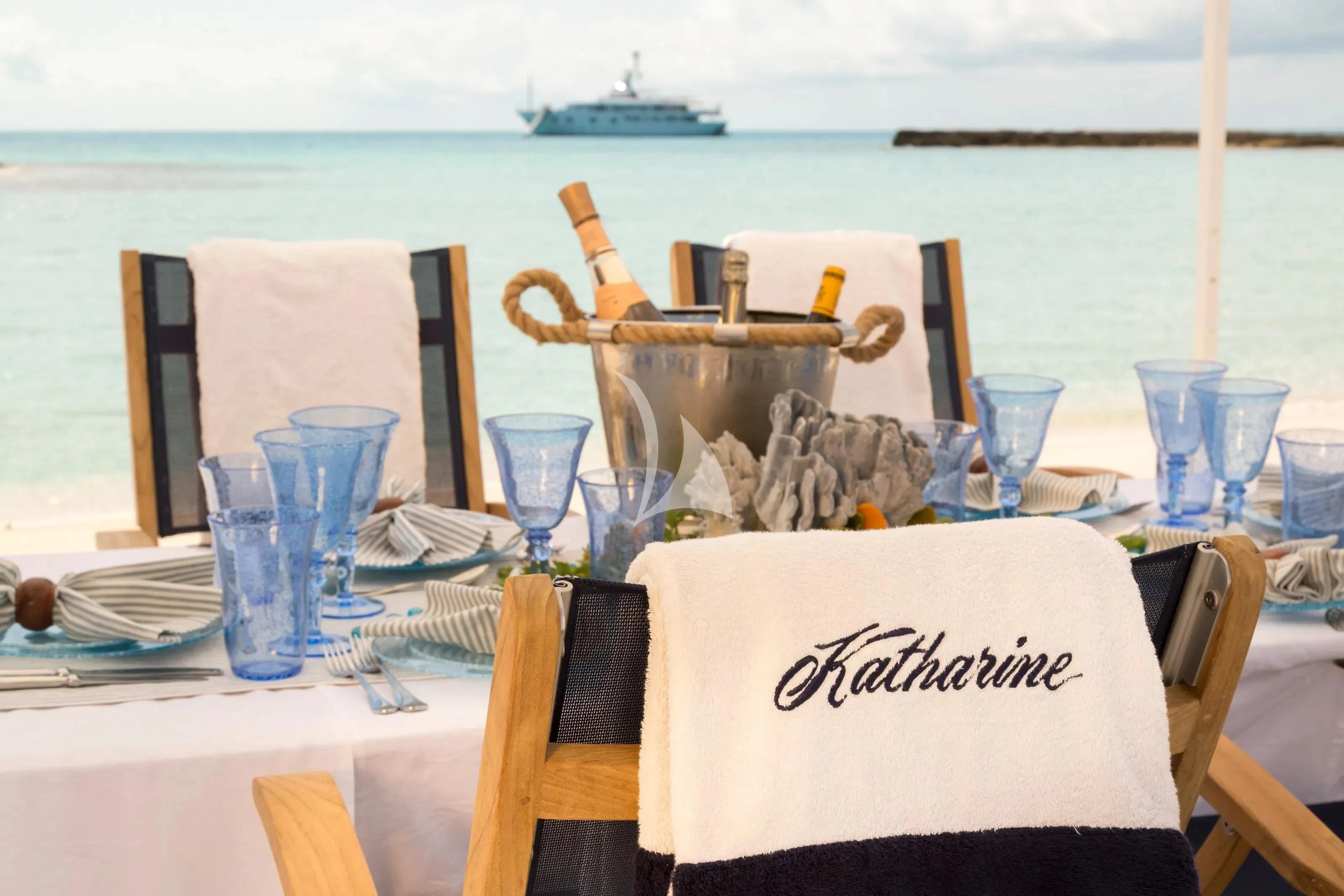 a table set with blue glasses and food on it aboard KATHARINE Yacht for Sale