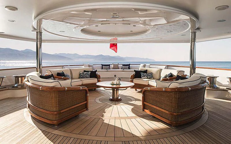 a room with a couch and a table and a large body of water aboard KATHARINE Yacht for Sale