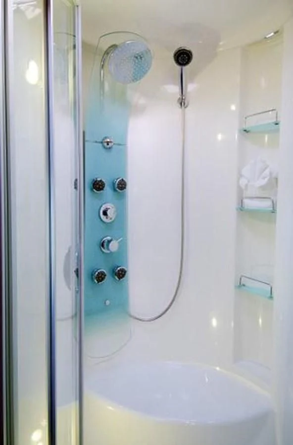 a white bathtub with a shower head and a shower head aboard 74' PRIVILEGE 2010 Yacht for Sale