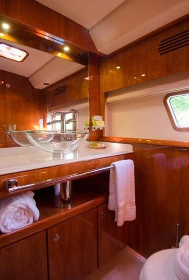a kitchen with a sink and cabinets aboard 74' PRIVILEGE 2010 Yacht for Sale