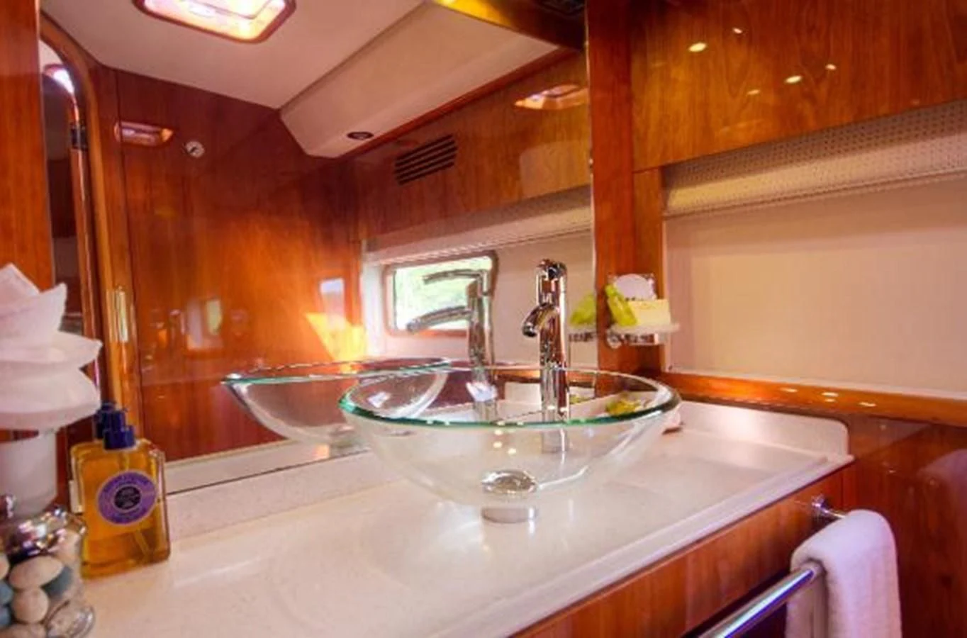 a bathroom with a sink and a mirror aboard 74' PRIVILEGE 2010 Yacht for Sale