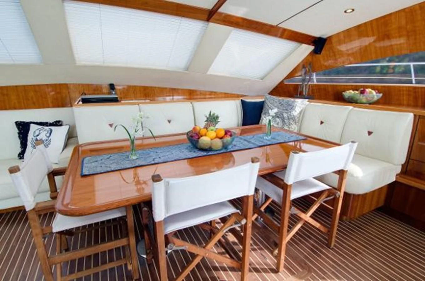 a kitchen with a table and chairs aboard 74' PRIVILEGE 2010 Yacht for Sale