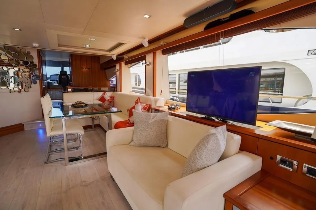 a living room with a large screen aboard LI-JOR Yacht for Sale