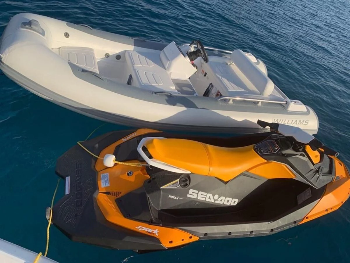 a couple of boats on the water aboard LI-JOR Yacht for Sale