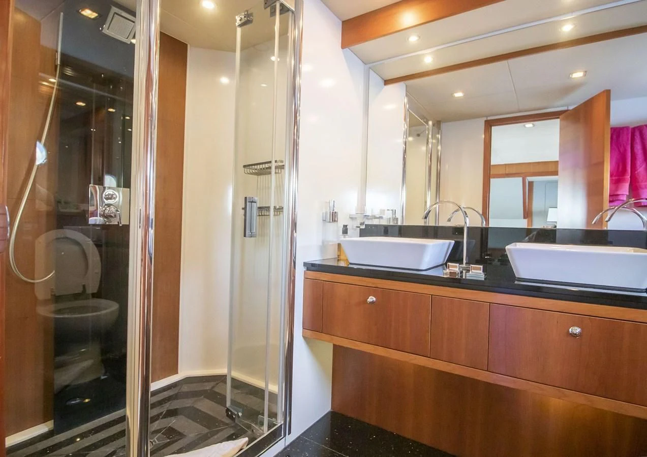 a bathroom with a glass shower aboard LI-JOR Yacht for Sale