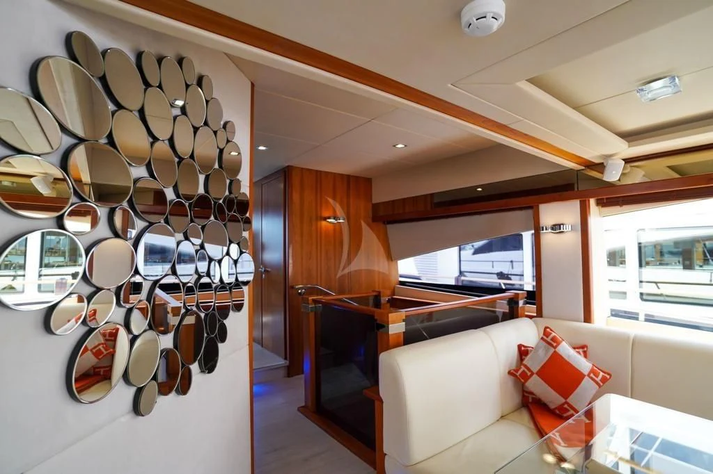 a room with a piano and a chandelier aboard LI-JOR Yacht for Sale
