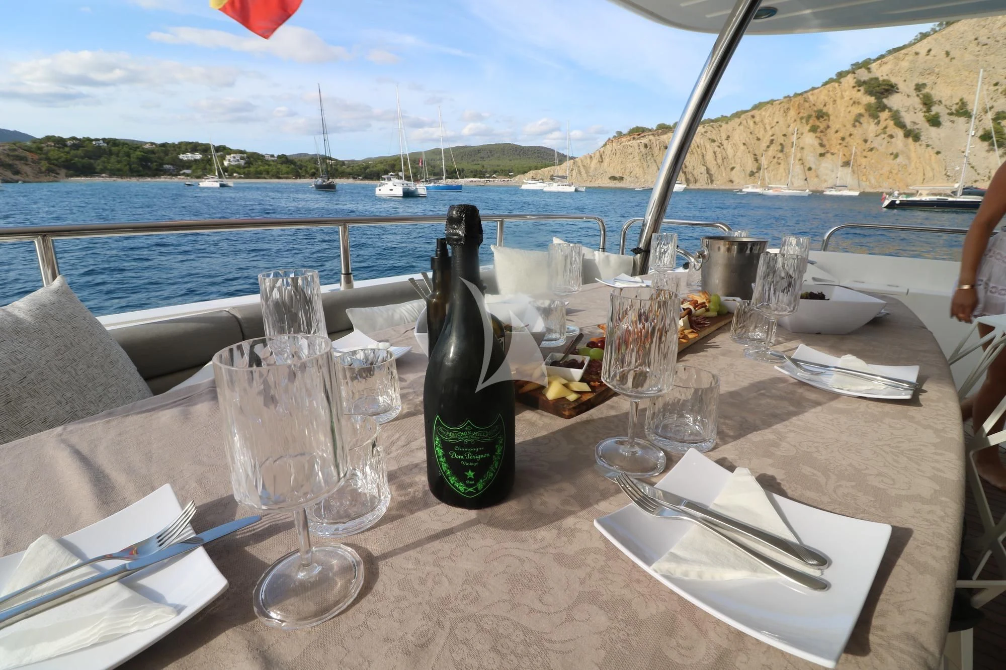 a table with wine glasses and bottles on it aboard LI-JOR Yacht for Sale