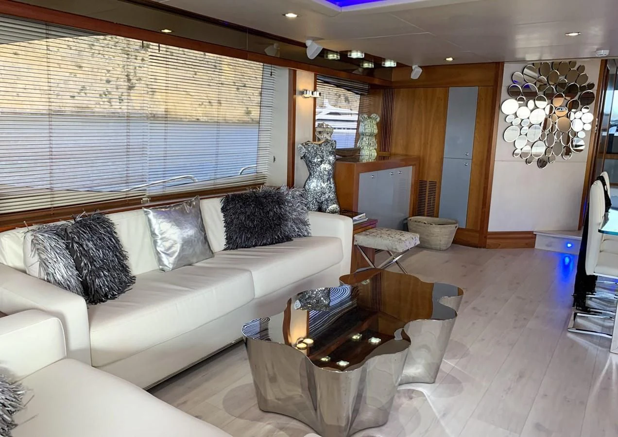 a living room with a couch and a coffee table aboard LI-JOR Yacht for Sale