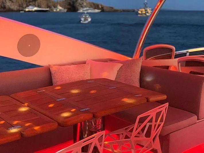 a table with chairs on it by the water aboard LI-JOR Yacht for Sale