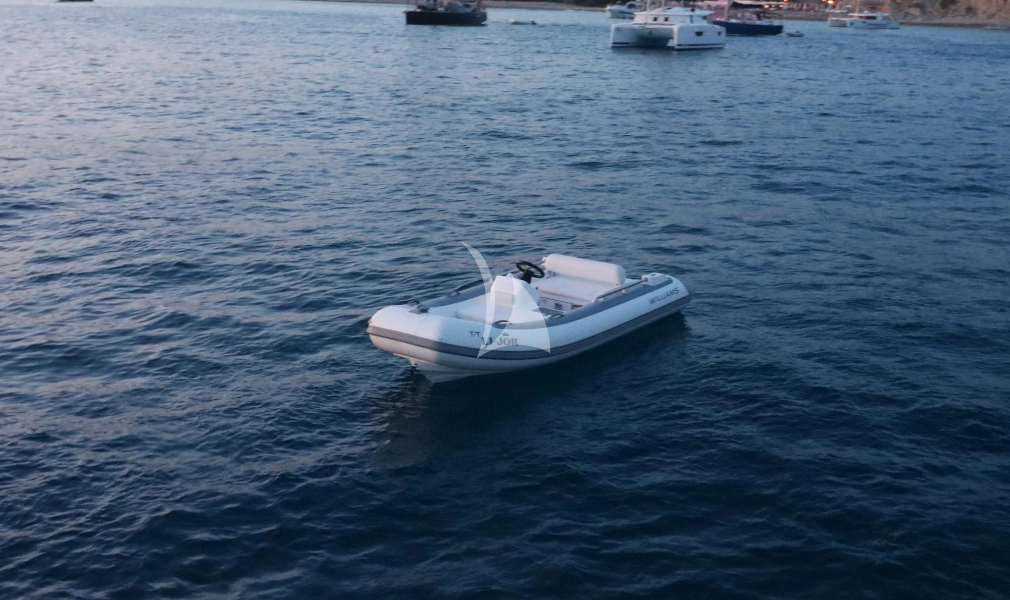 a small white boat in the water aboard LI-JOR Yacht for Sale