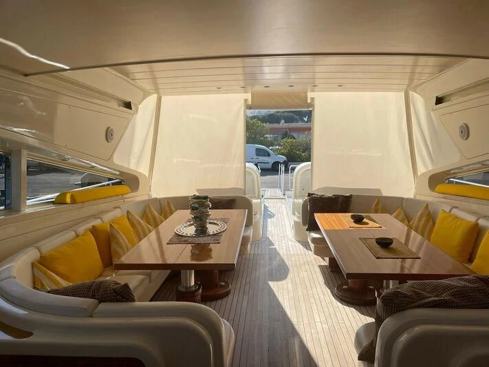 a room with a table and chairs aboard DG Yacht for Sale