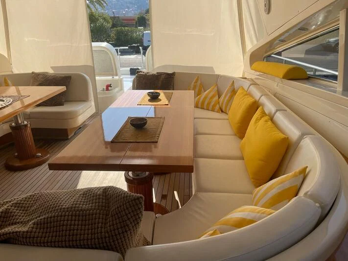 a living room with a couch and a table aboard DG Yacht for Sale