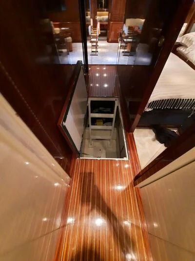 a room with a wood floor and a staircase aboard DG Yacht for Sale