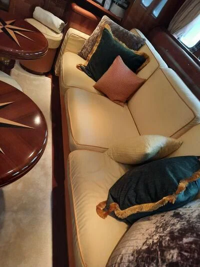 a cat lying on a couch aboard DG Yacht for Sale