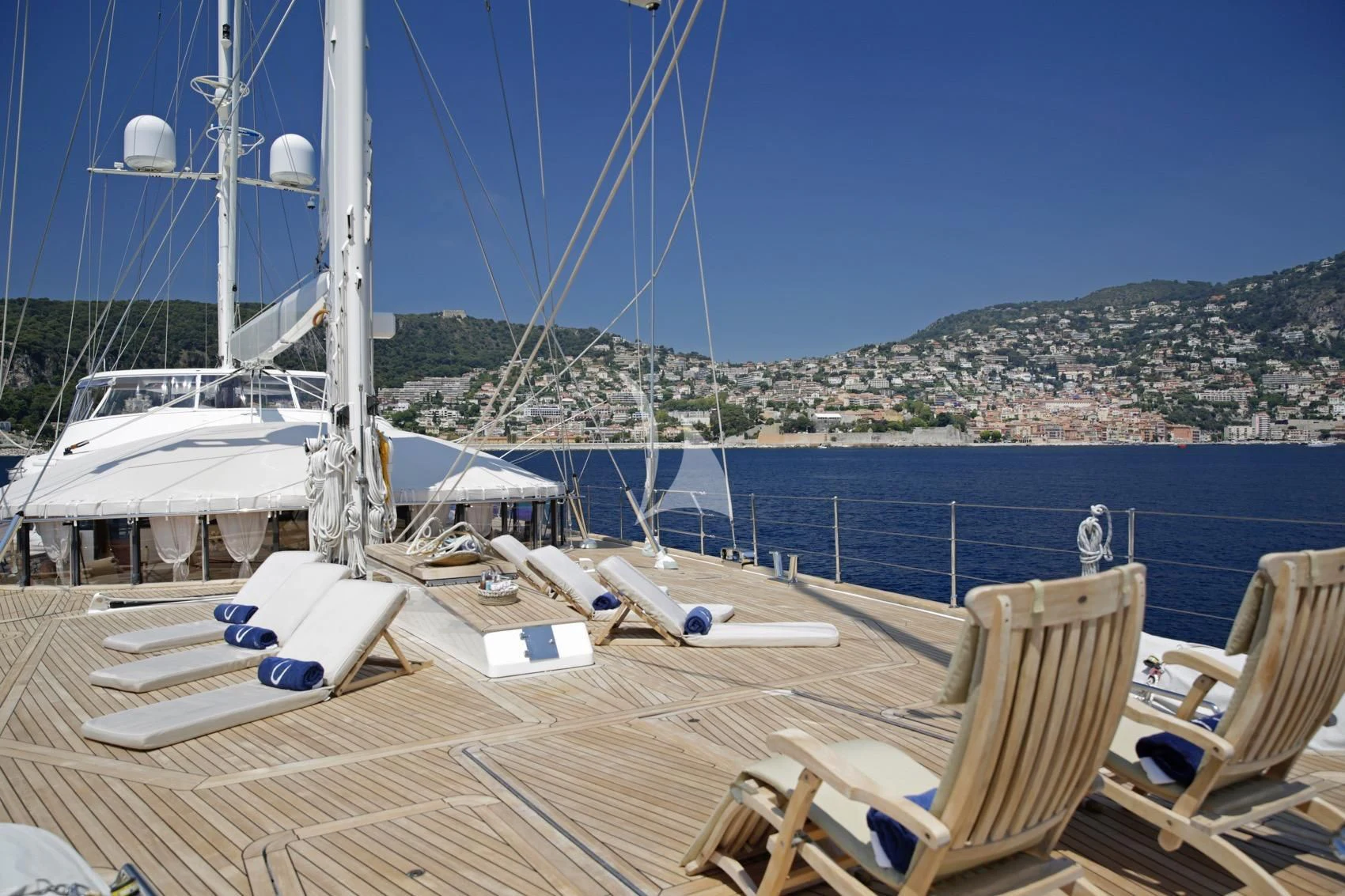 a deck with chairs and a boat on it aboard LA LUNA Yacht for Sale