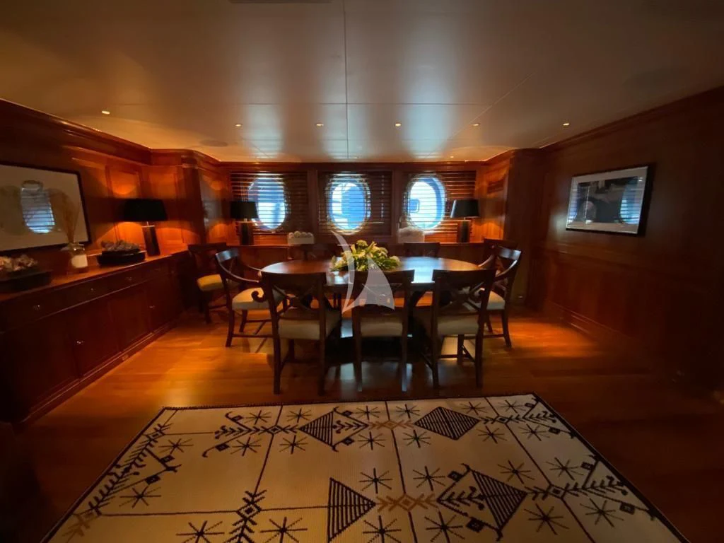 a dining room with a table and chairs aboard LA LUNA Yacht for Sale