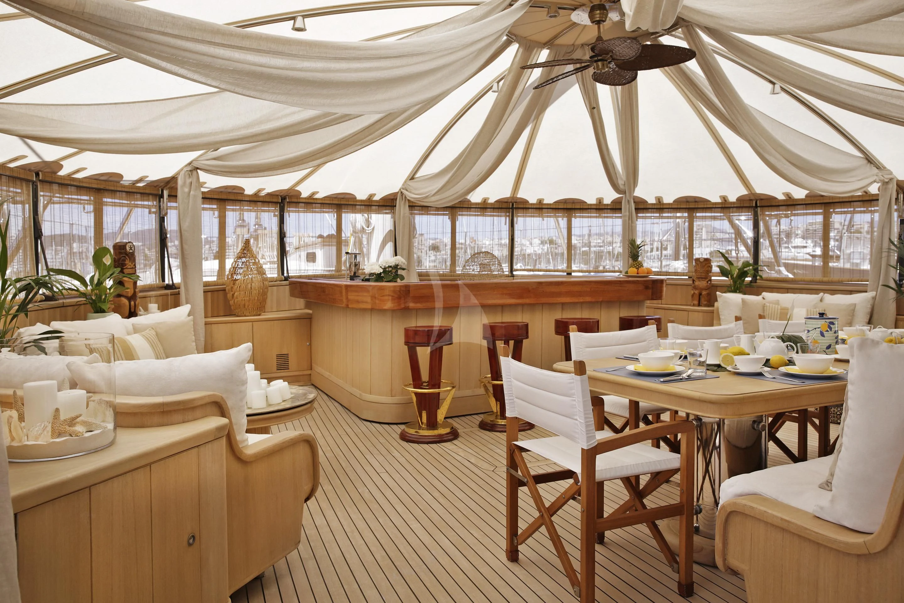 a large room with a table and chairs and a large window aboard LA LUNA Yacht for Sale