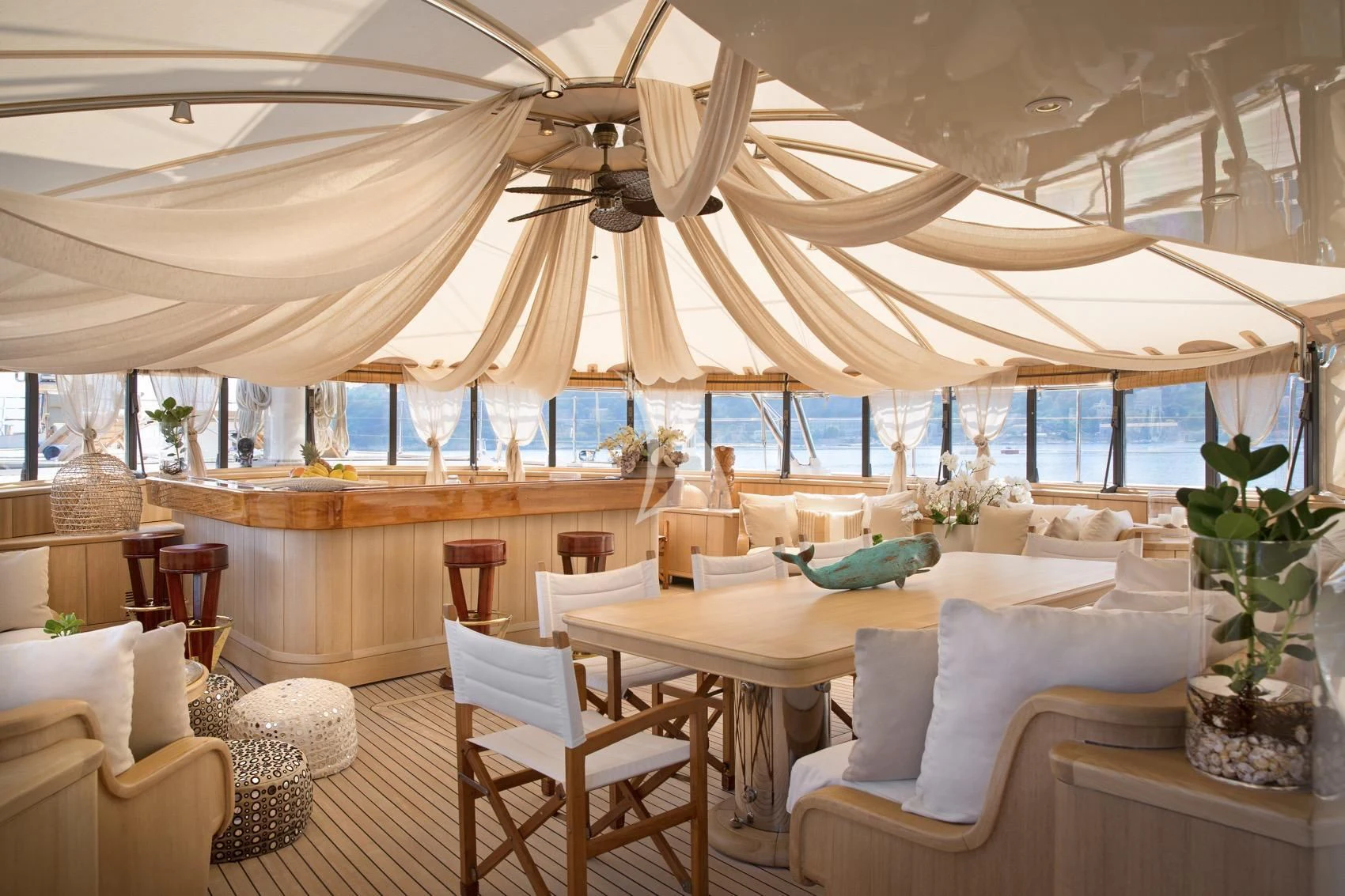 a large room with tables and chairs aboard LA LUNA Yacht for Sale