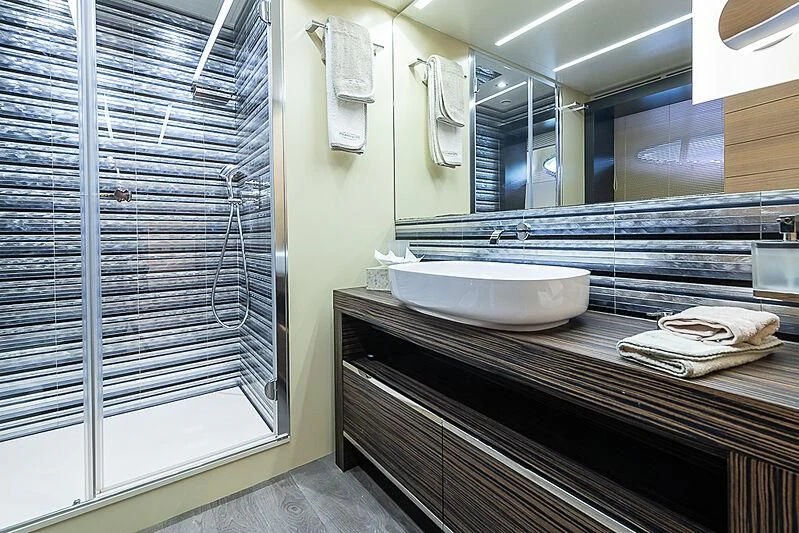 a bathroom with a sink and a mirror aboard KIKI V Yacht for Sale