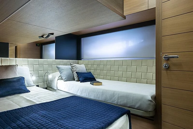 a room with a bed and a wood cabinet aboard KIKI V Yacht for Sale