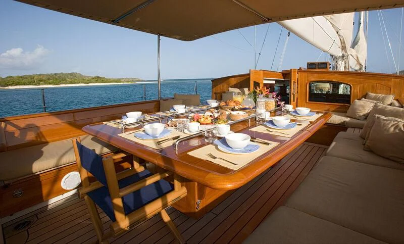 a table with plates and cups on it aboard WINDROSE OF AMSTERDAM Yacht for Sale