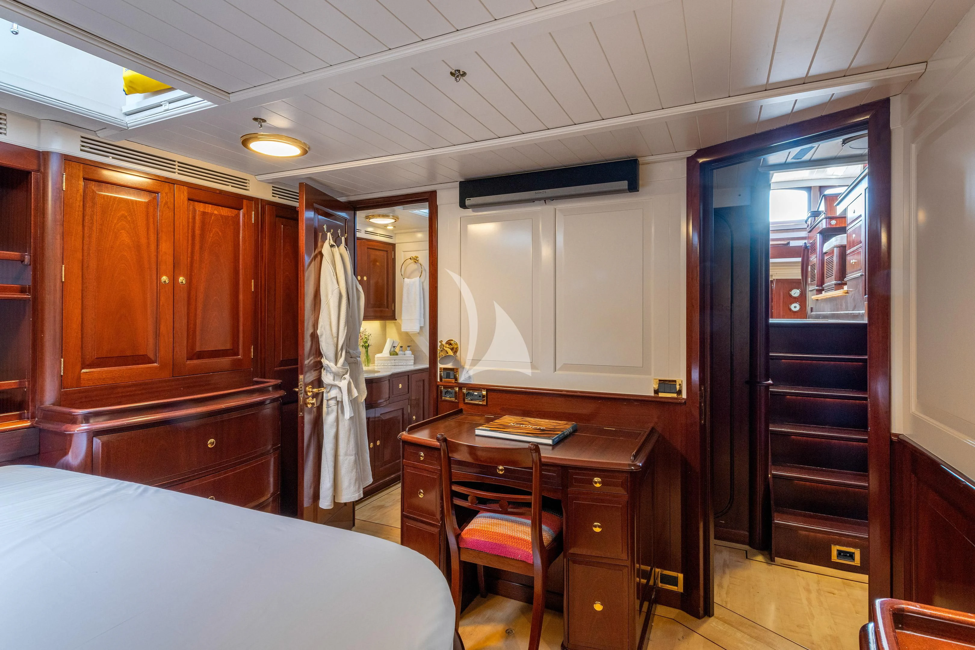 a bedroom with a desk and a bed aboard WINDROSE OF AMSTERDAM Yacht for Sale