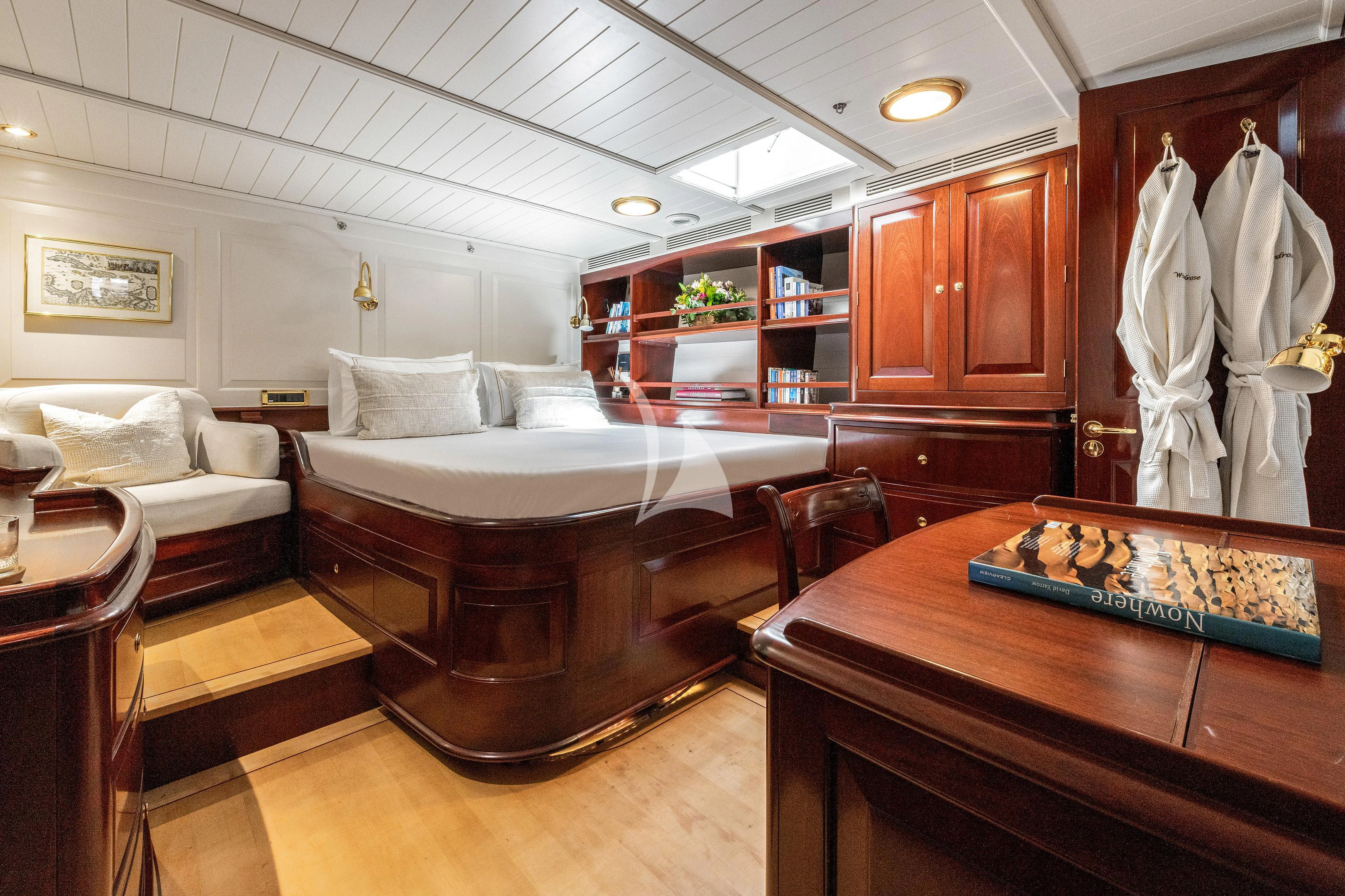 a room with a bed and a table aboard WINDROSE OF AMSTERDAM Yacht for Sale