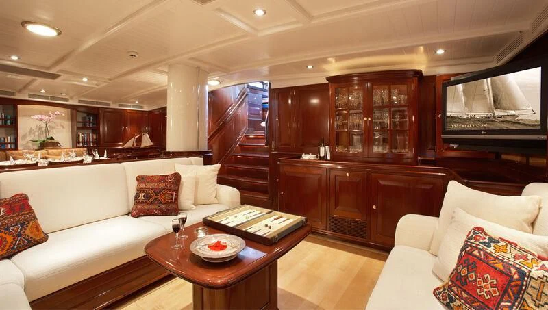 a living room with a white couch and a television aboard WINDROSE OF AMSTERDAM Yacht for Sale