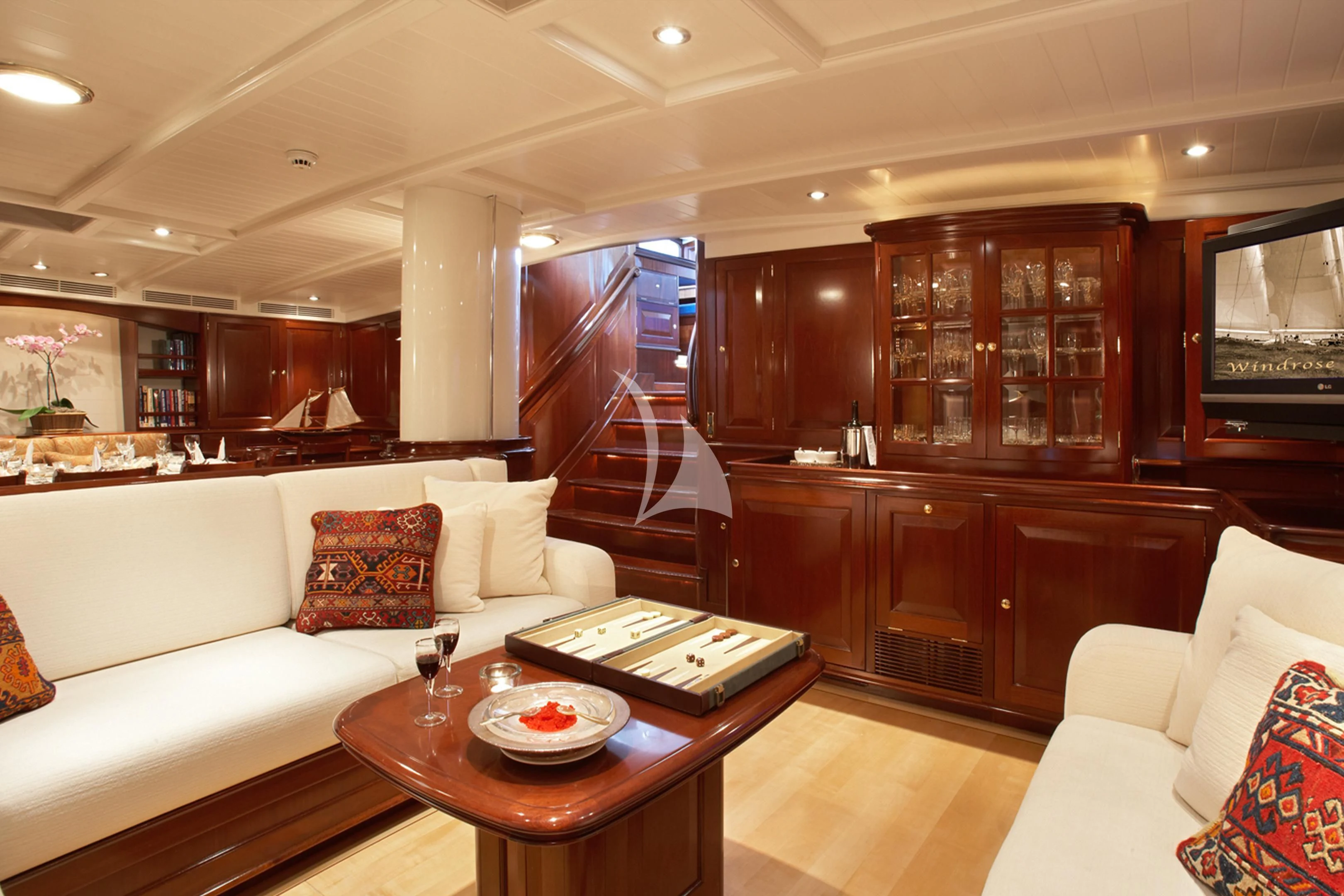 a living room with a couch and a table aboard WINDROSE OF AMSTERDAM Yacht for Sale