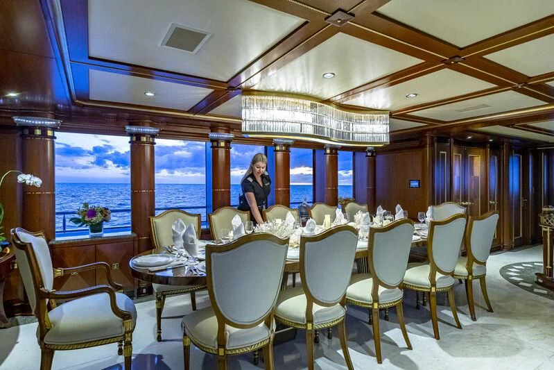 a person sitting at a table aboard STARSHIP Yacht for Charter