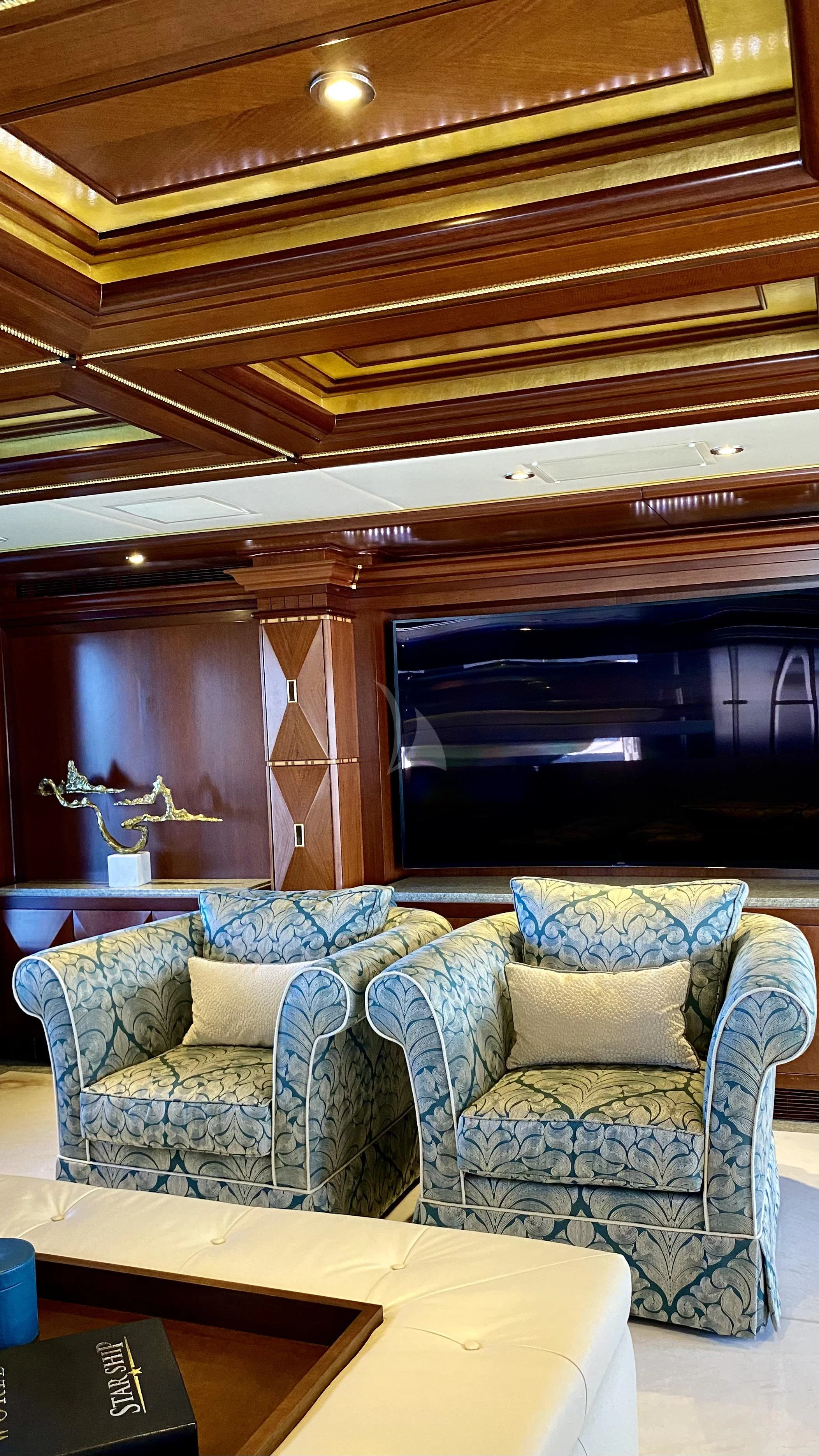 a room with couches and a table aboard STARSHIP Yacht for Charter