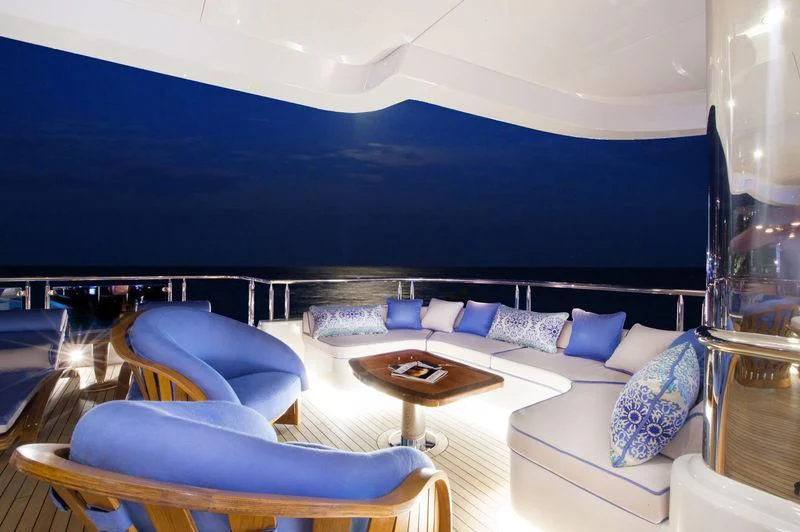 a room with a couch and a table aboard STARSHIP Yacht for Charter