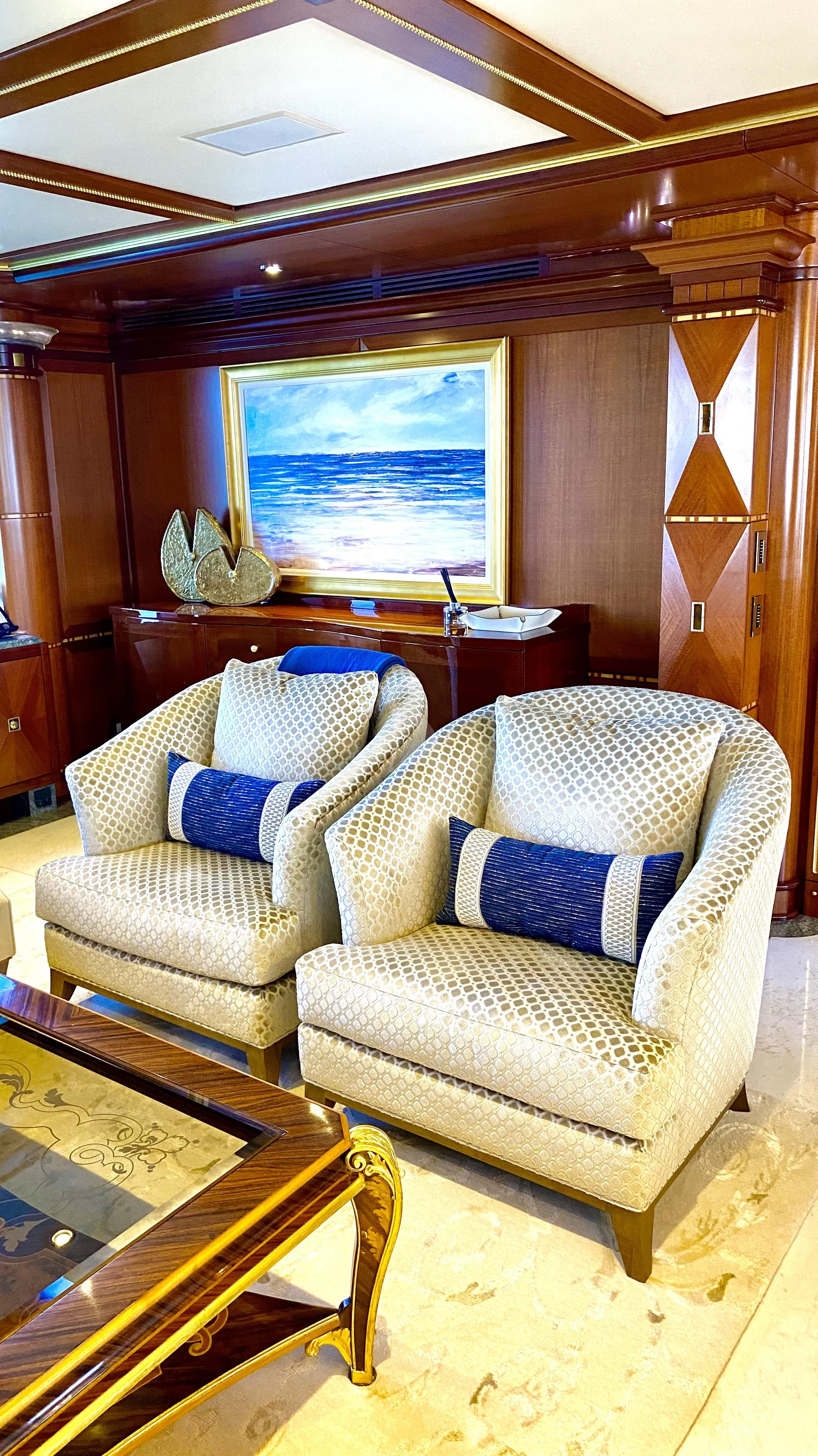 a living room with a couch and a table aboard STARSHIP Yacht for Charter