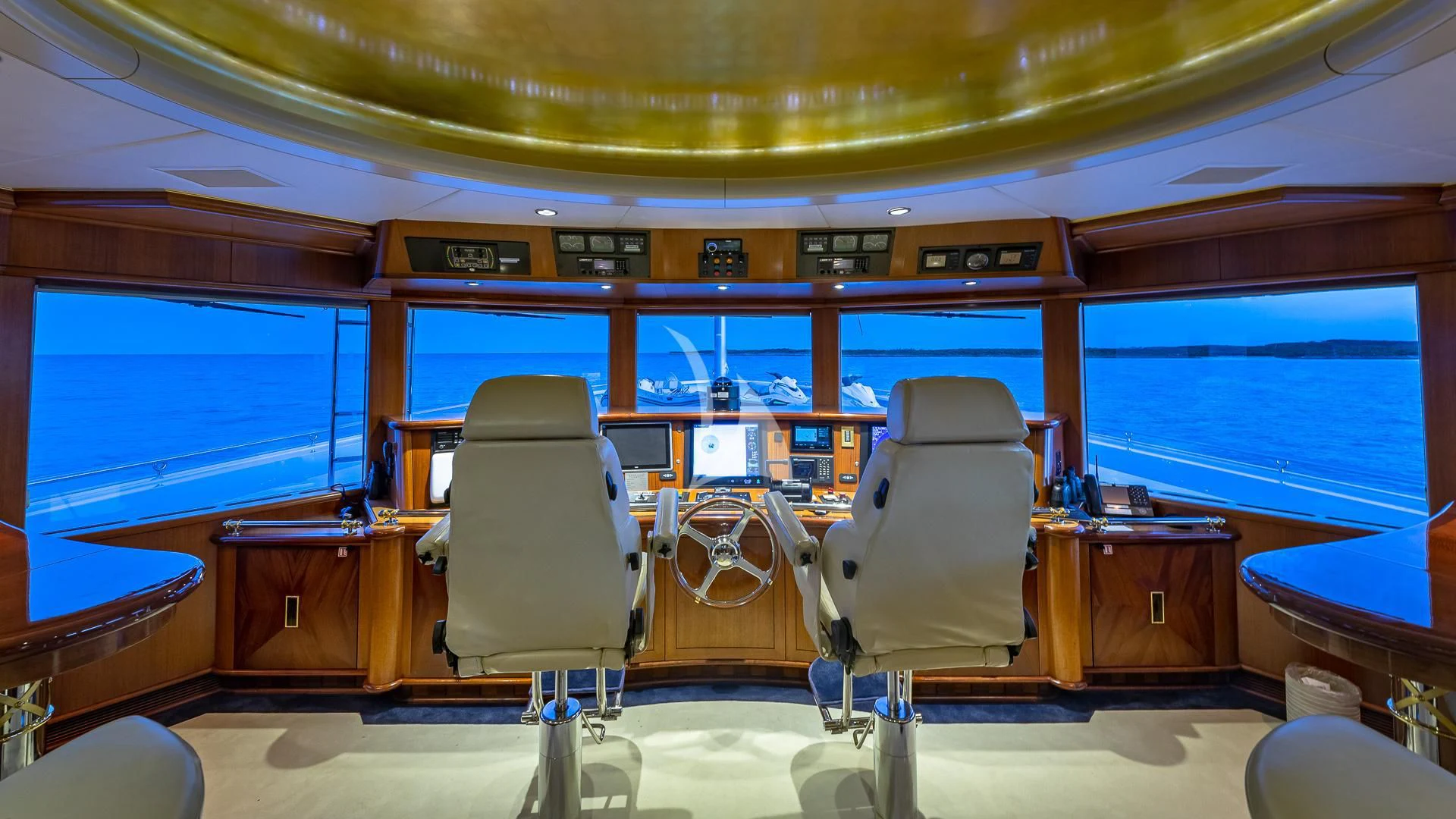 a room with a desk and chairs aboard STARSHIP Yacht for Charter