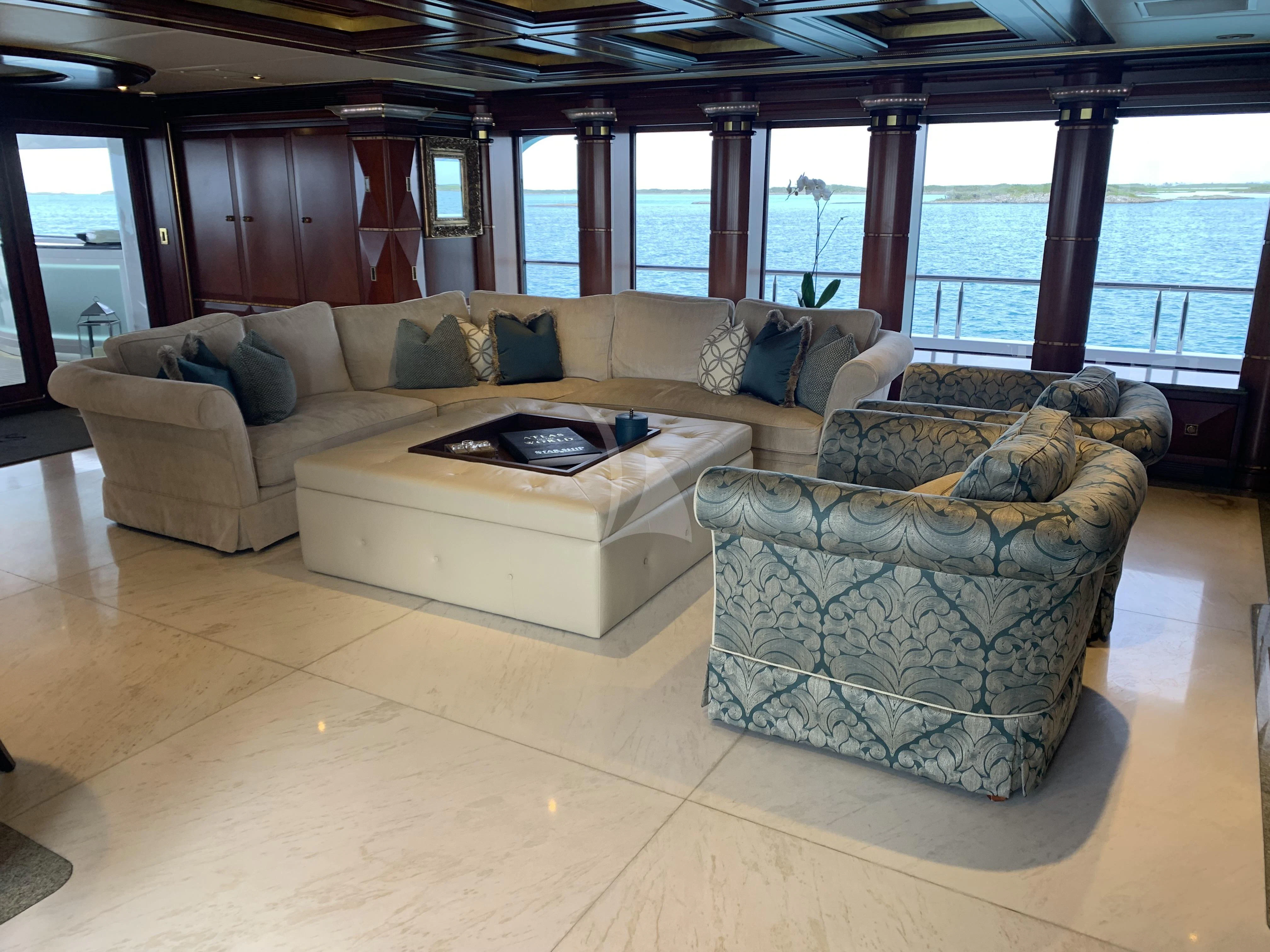 a living room with a couch and a table aboard STARSHIP Yacht for Charter