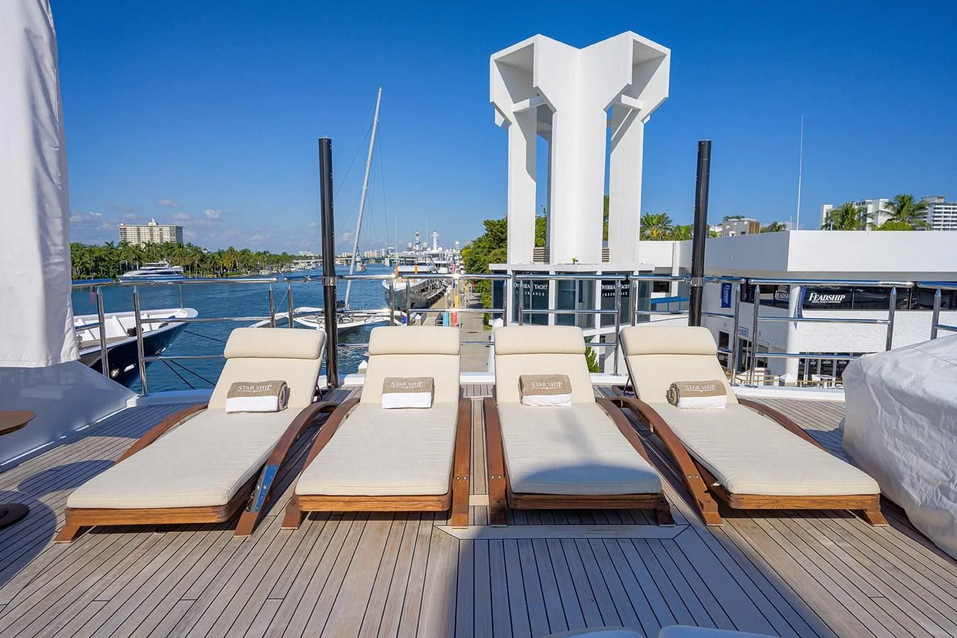 a deck with chairs and tables on it aboard STARSHIP Yacht for Charter