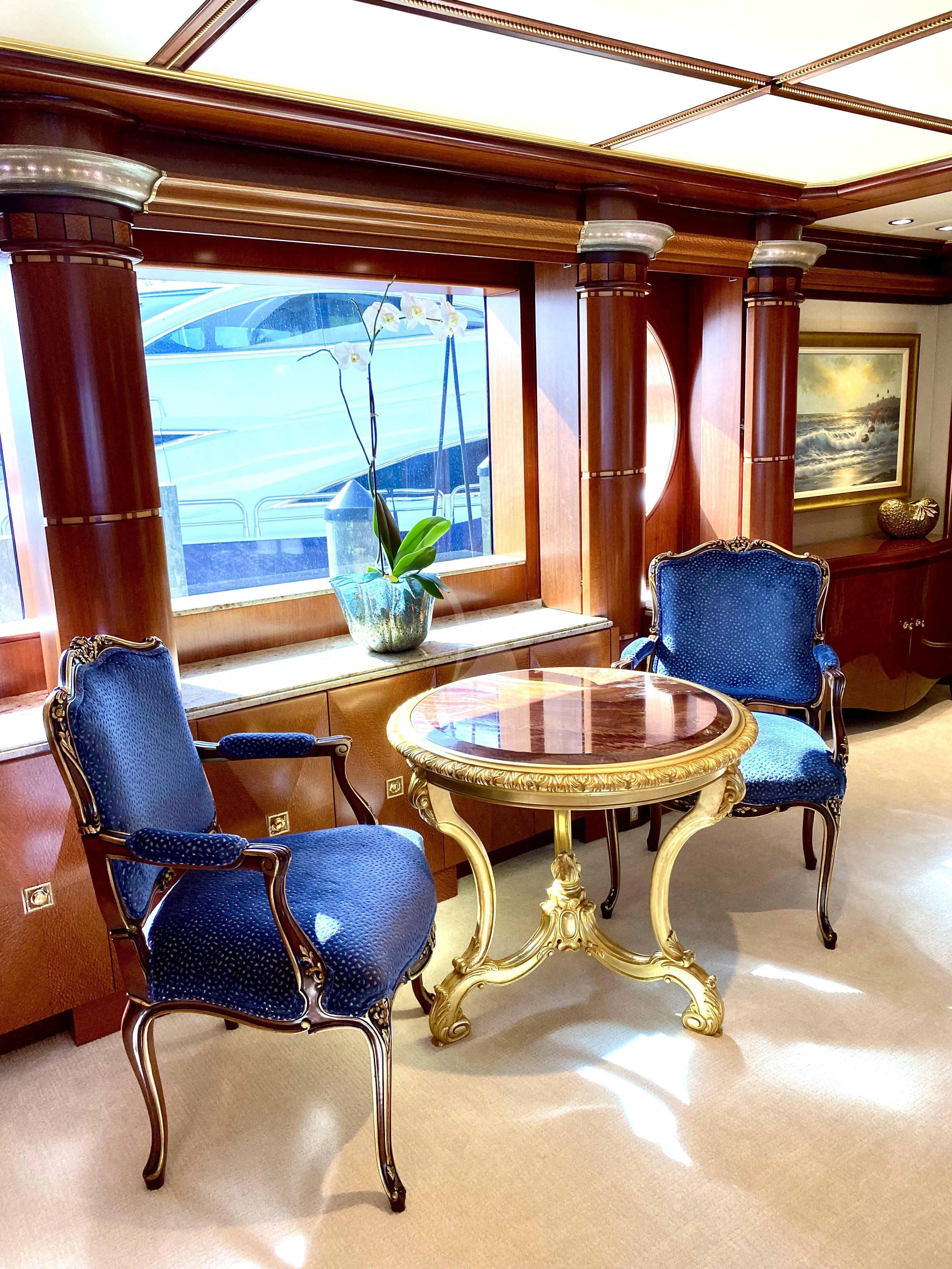 a room with a table and chairs aboard STARSHIP Yacht for Charter