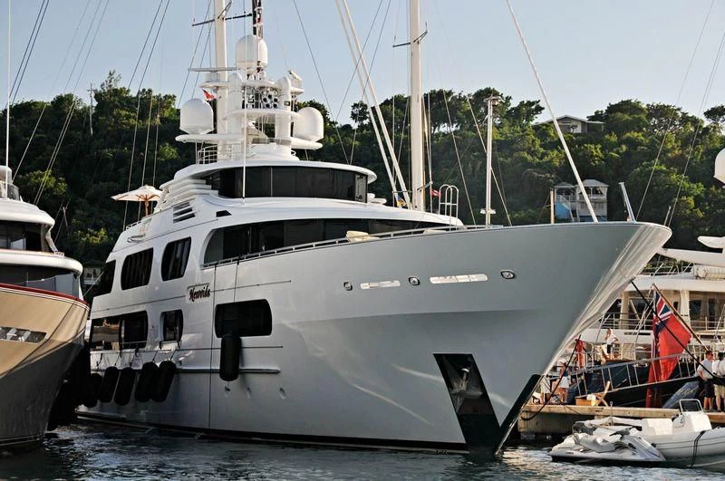 a boat docked at a pier aboard STARSHIP Yacht for Charter