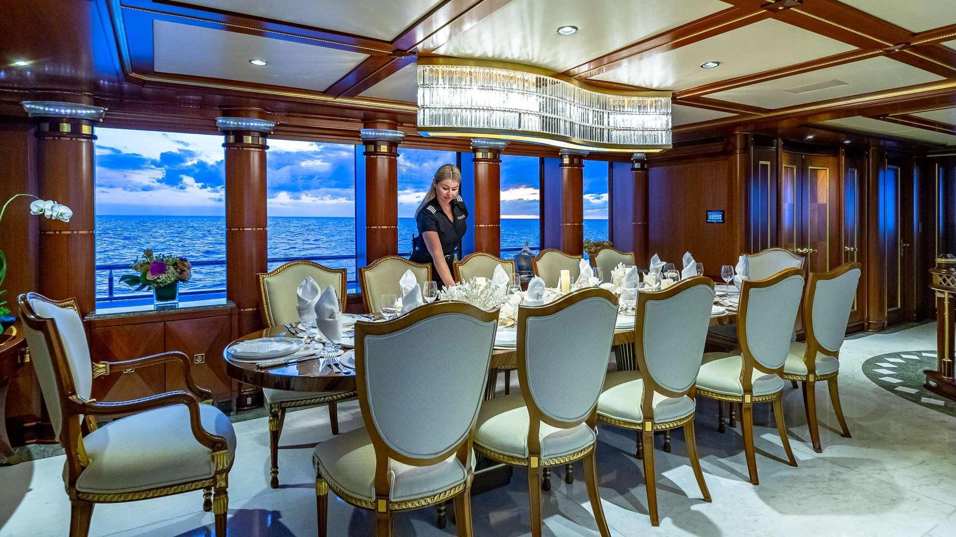 a person sitting at a table aboard STARSHIP Yacht for Charter