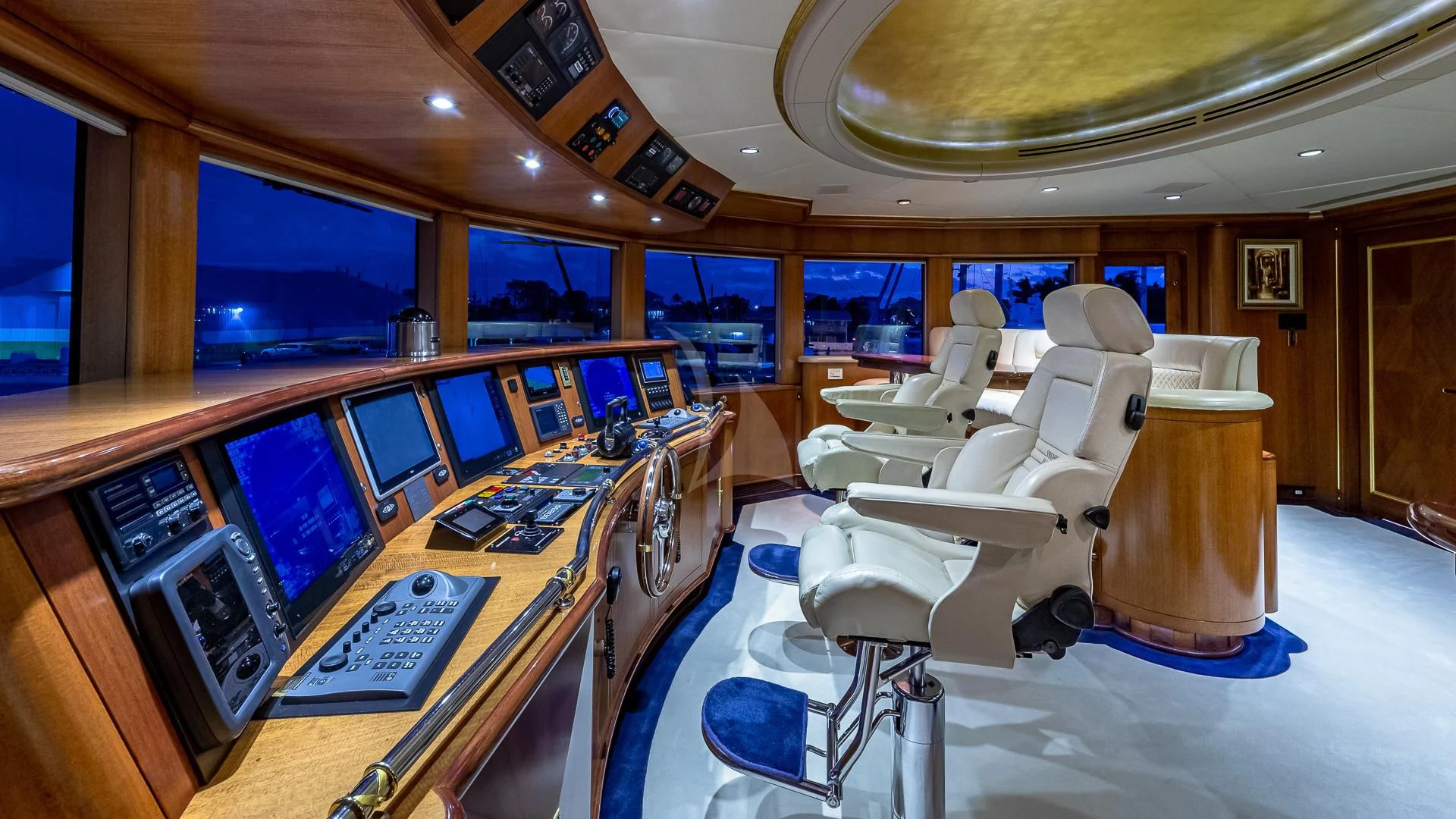 a room with a table chairs and computers aboard STARSHIP Yacht for Charter