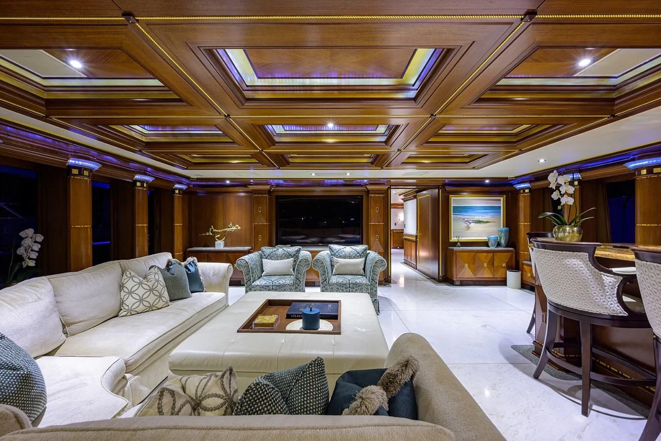 a living room with a couch and a table aboard STARSHIP Yacht for Charter
