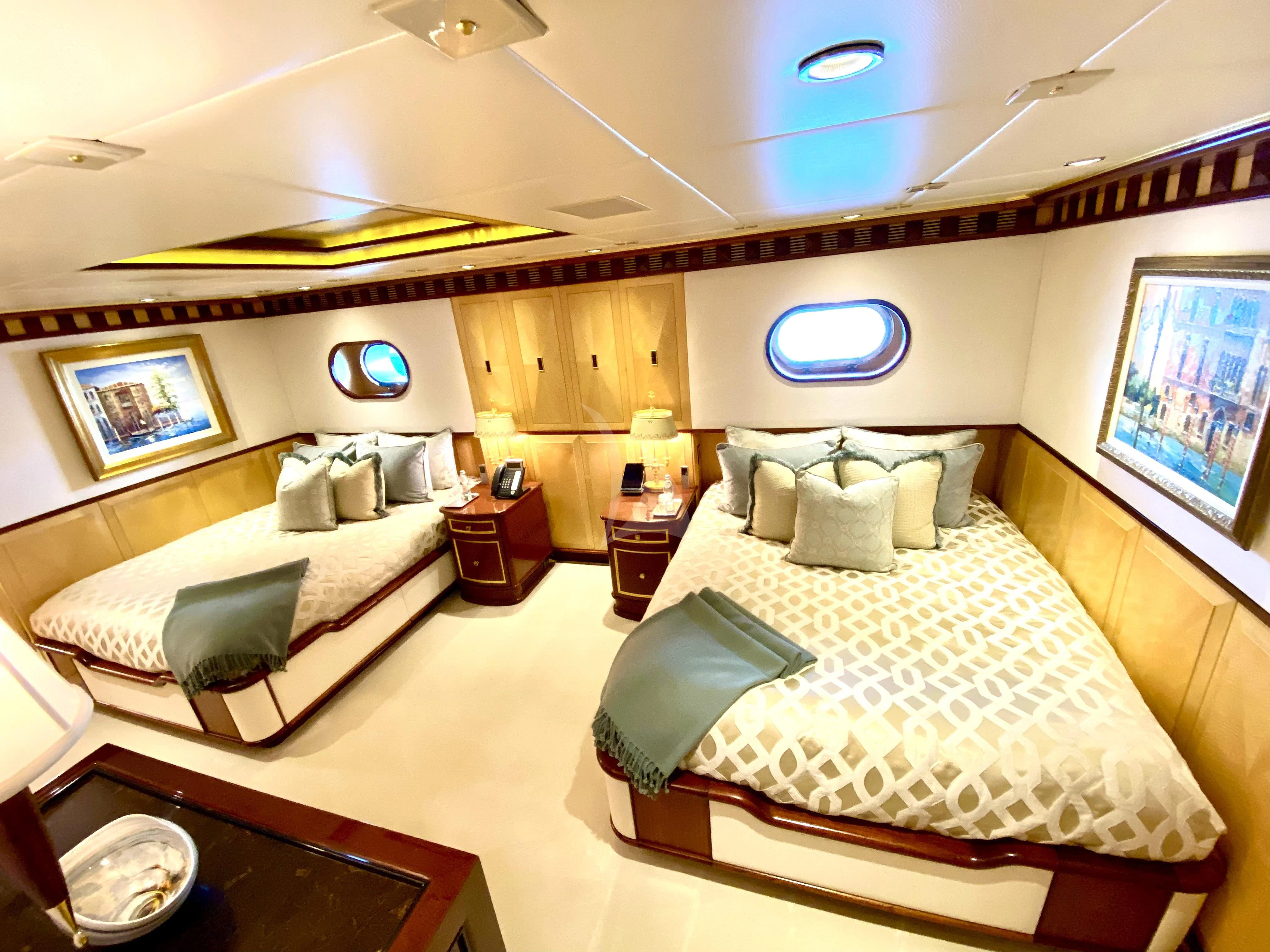 a couple of beds in a hotel room aboard STARSHIP Yacht for Charter