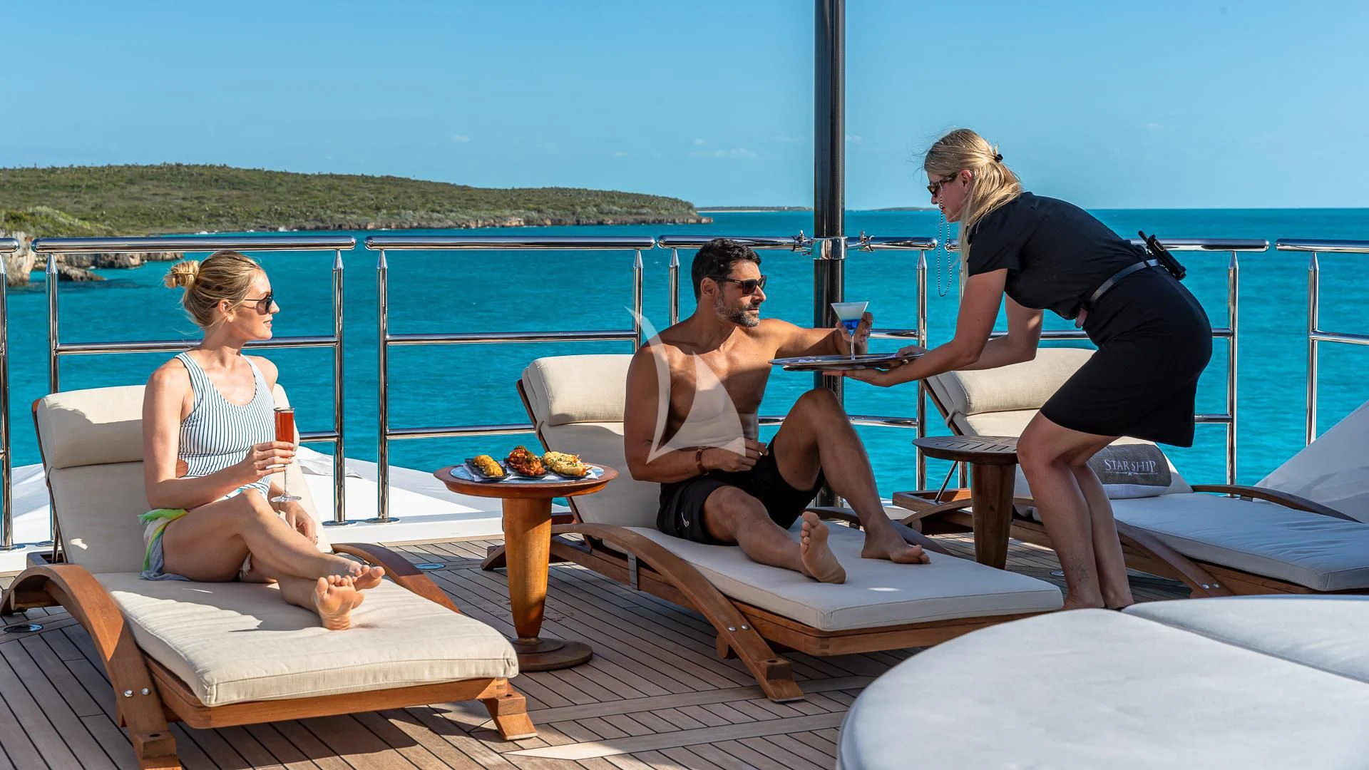 a group of people sitting on a boat aboard STARSHIP Yacht for Charter