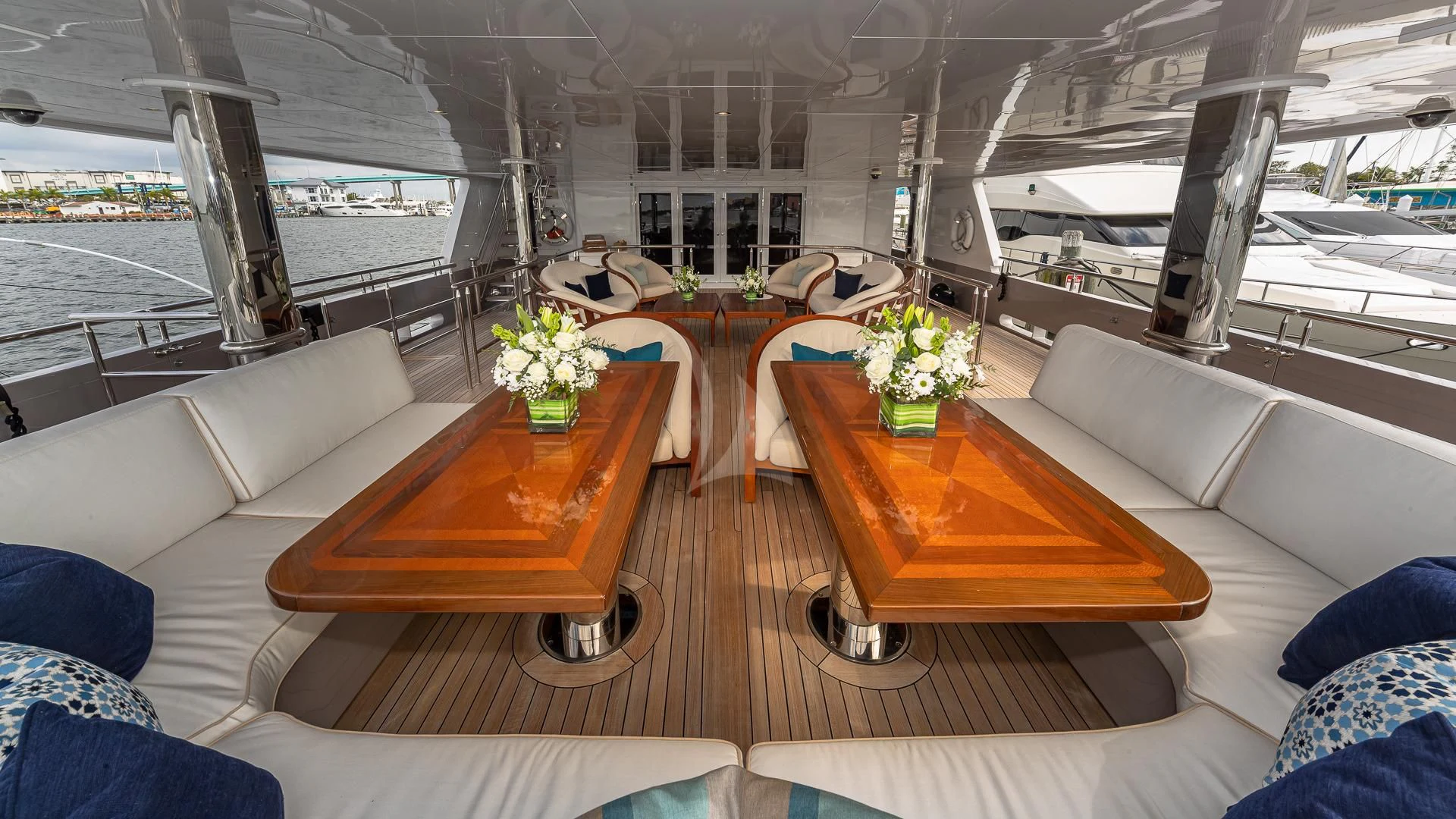 a room with a table and couches aboard STARSHIP Yacht for Charter